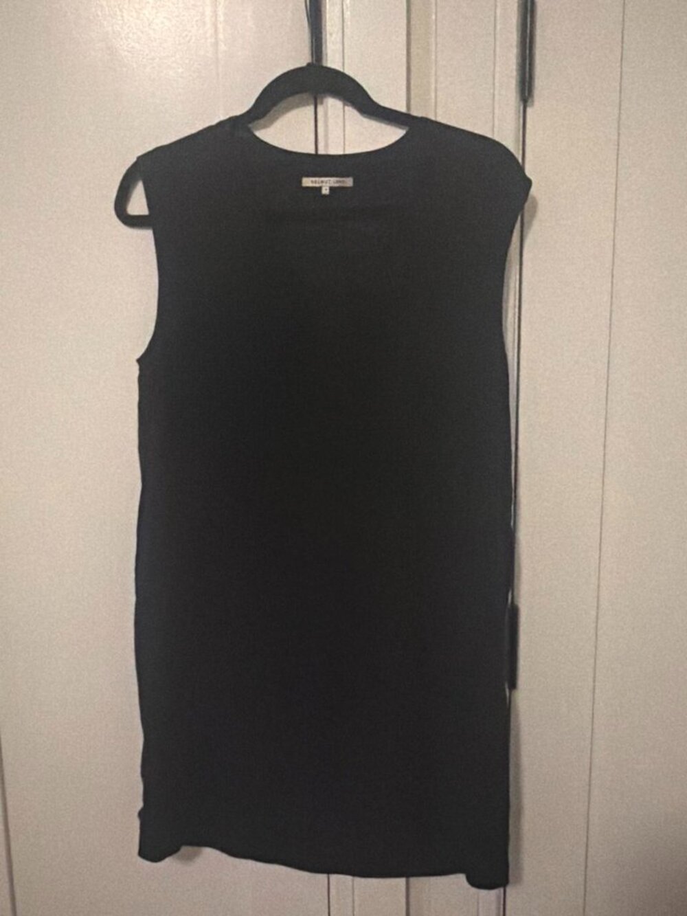 Black sleeveless mini dress with pockets
